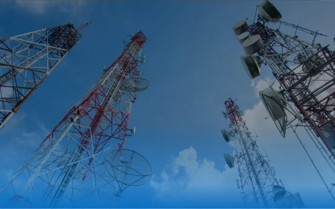 upward view of four cellular towers