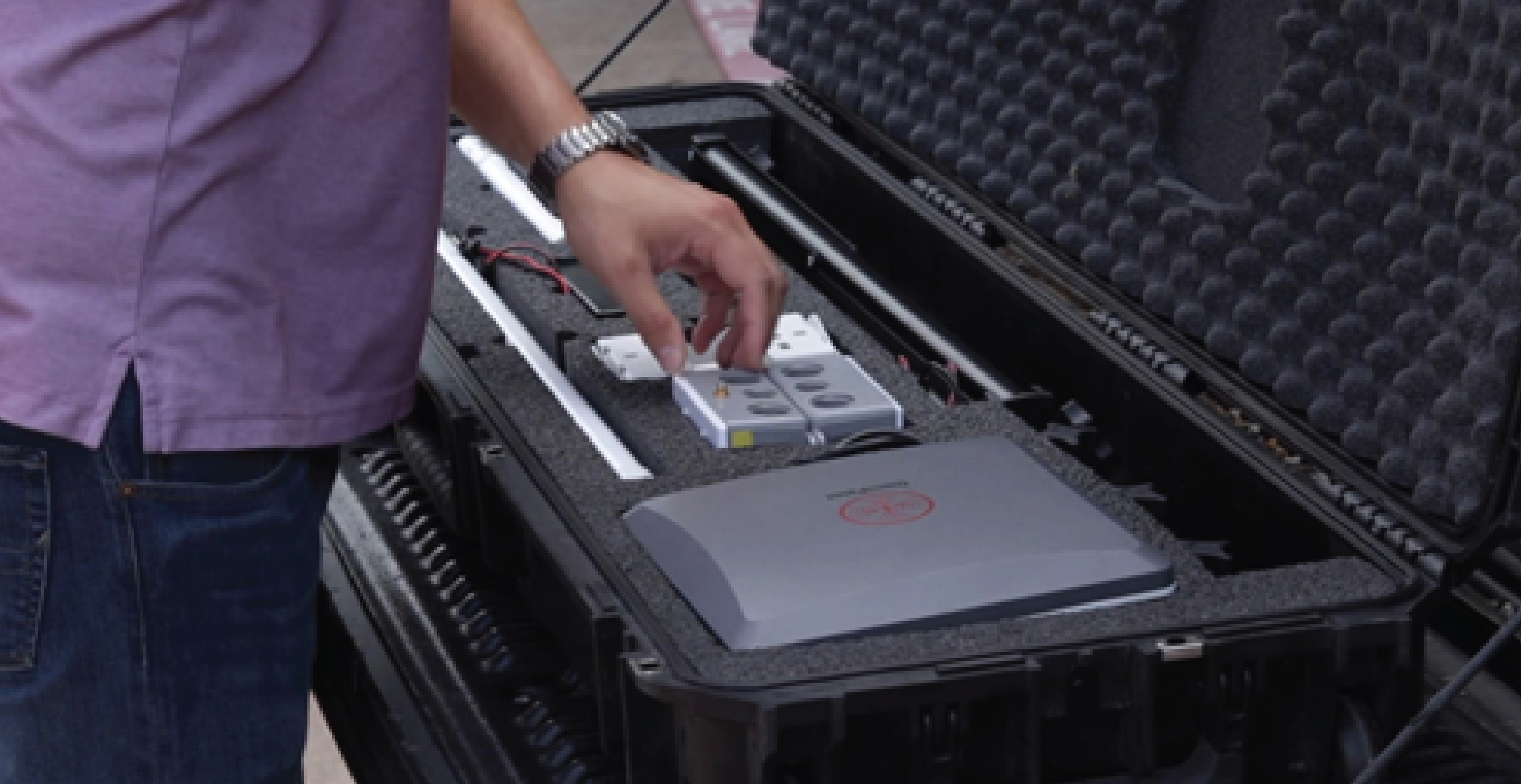 Closeup of a man and an open OmniPoint demo kit box