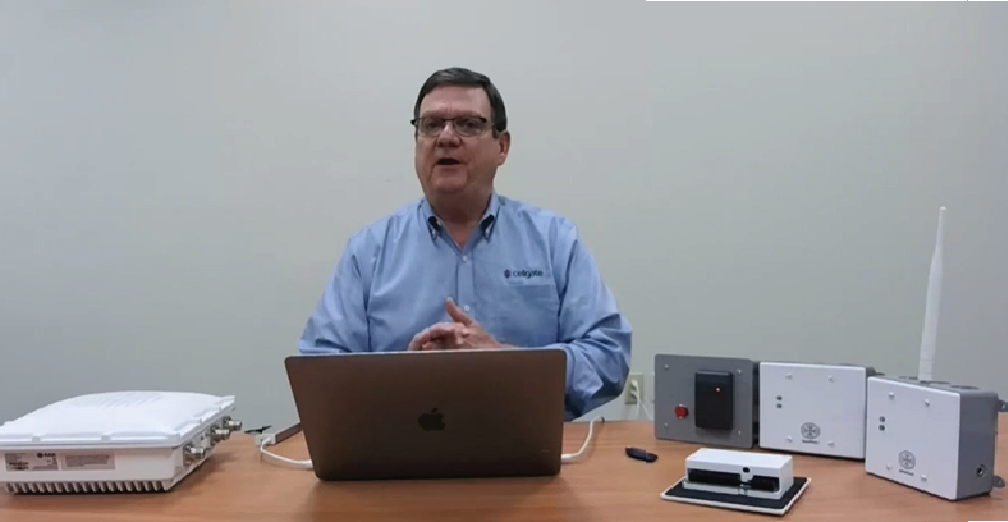 CellGate Founder Noel Gouldin seated at a desk with his laptop in front of him