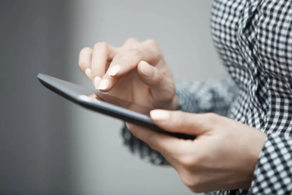 Woman using a tablet to issue Vitual Keys for a visitor