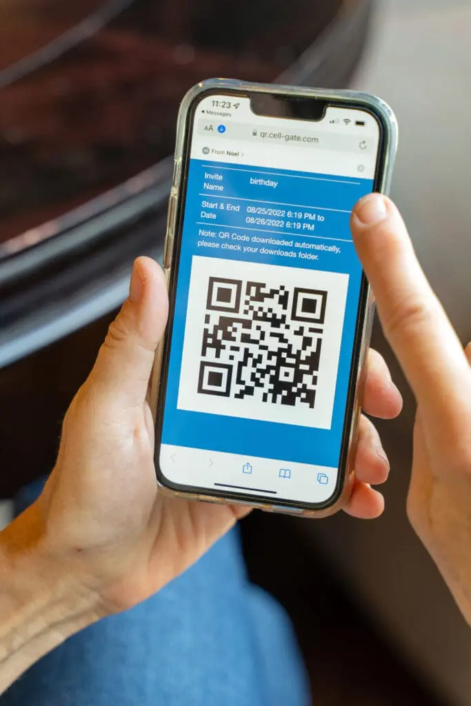 Hands holding smartphone displaying CellGate guest QR code access invitation with date range and downloadable QR code