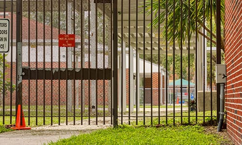 black fence at school property protected by cellgate access control solutions
