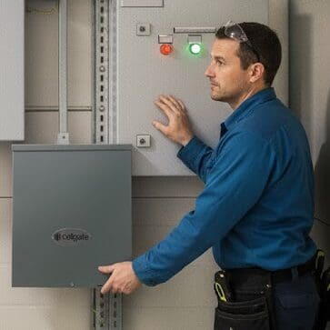 Technician installing intercom with checklist